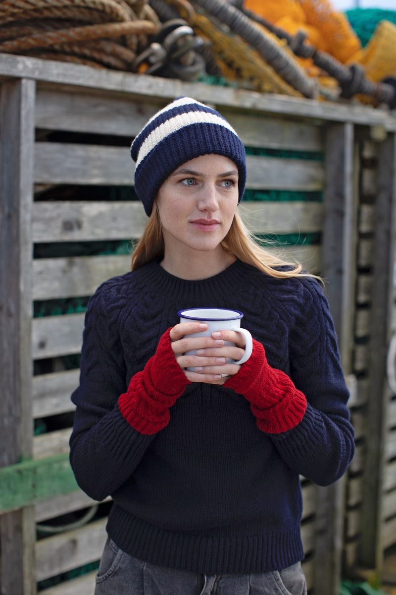 SI622Z Yoke Cabled Navy Jumper | Fisherman Out of Ireland at Sarah Thomson | Styled on model with mitts and cup of tea