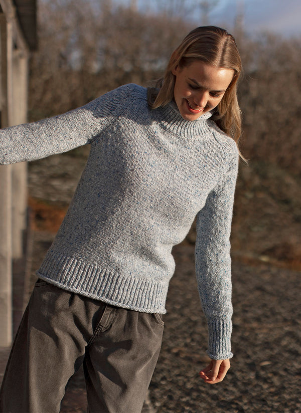 Roll Neck Wool Sweater in Blue Mist | Fisherman Out of Ireland at Sarah Thomson | On model in lifestyle image