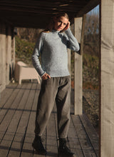 Roll Neck Wool Sweater in Blue Mist | Fisherman Out of Ireland at Sarah Thomson | Styled with trousers and boots on model