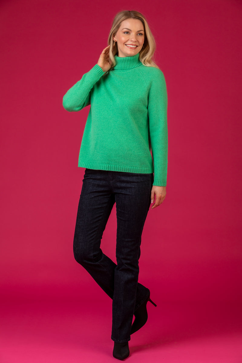 Bright Green Roll Neck Cashmere Jumper | Esthēme Cachemire at Sarah Thomson | Styled on model with pink background