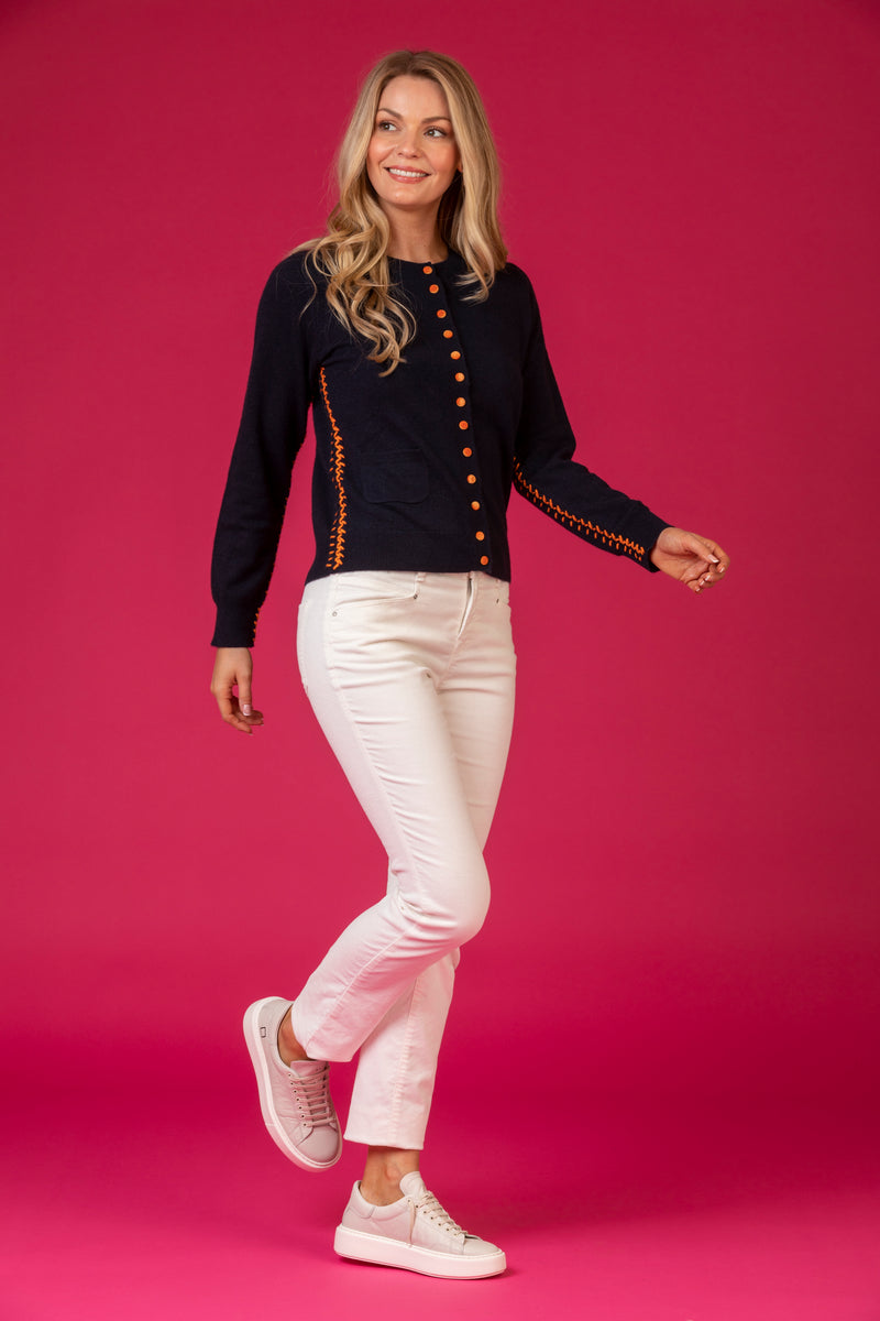 Cashmere Cardigan with Contrast Buttons and Stitching in Navy and Orange | Esthēme Cachemire at Sarah Thomson Melrose | Model styled on pink backdrop