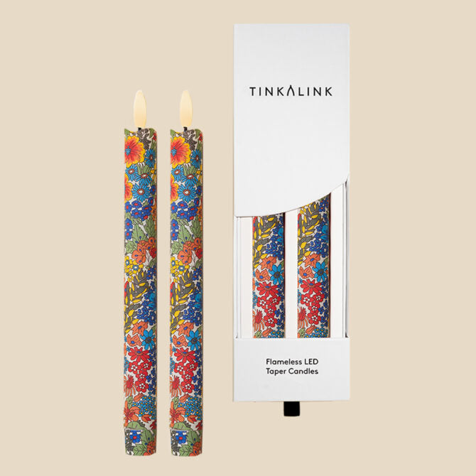 Floral-patterned LED candles with Tinkalink packaging on a beige background
