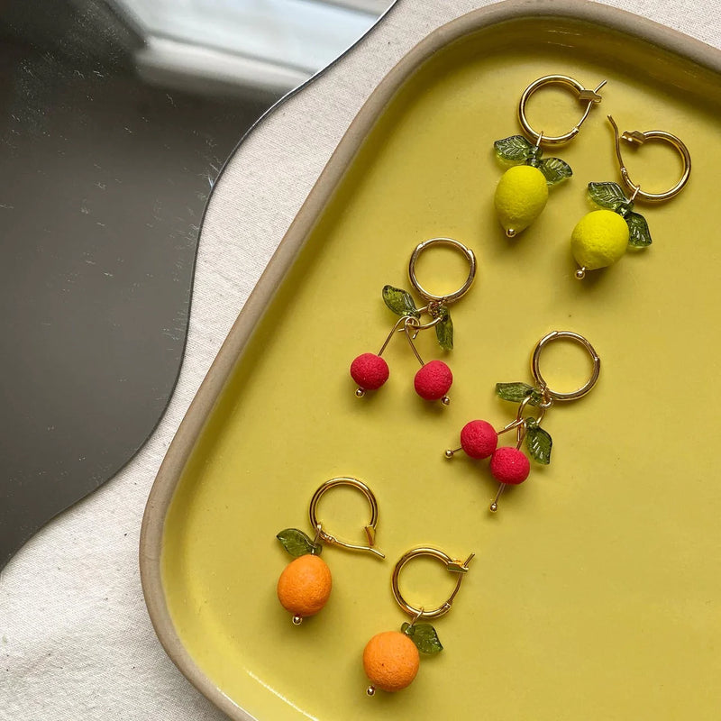 Orange Hoop Earrings | Love Kiki | Fruit earrings on a yellow tray